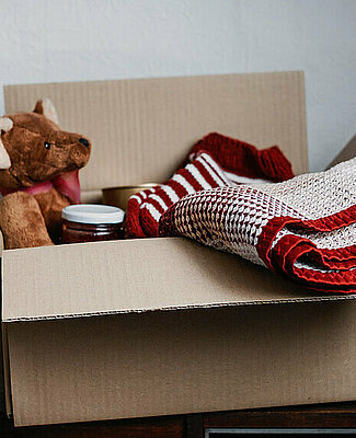 Donation box, Charity Gift hampers, Help Refugees and homeless. Christmas Xmas Charity Donation box with warm clothes, food and toys at home. Charities giving winter hampers to families in need