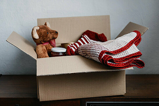 Donation box, Charity Gift hampers, Help Refugees and homeless. Christmas Xmas Charity Donation box with warm clothes, food and toys at home. Charities giving winter hampers to families in need