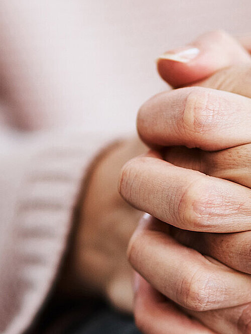 Cropped shot of a woman sitting on a sofa and feeling anxious